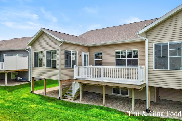 903 S Center Park Dr SW Unit 14, Byron Center, MI 49315 - rear view of house featuring a deck, a lawn, and roof with shingles