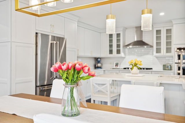 4396 Laurel Dr, Saint Joseph, MI 49085 - kitchen featuring appliances with stainless steel finishes, wall chimney exhaust hood, light countertops, white cabinetry, and recessed lighting