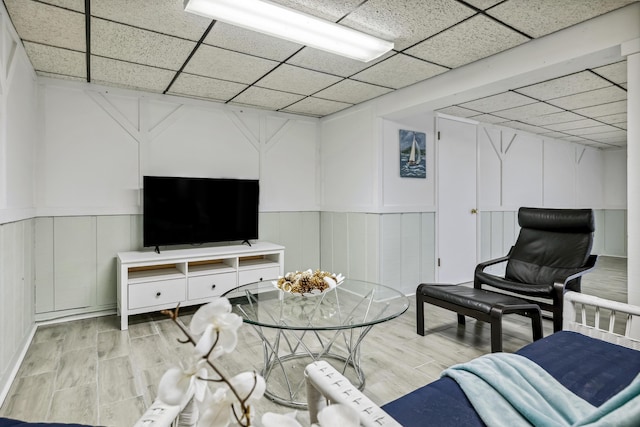 4396 Laurel Dr, Saint Joseph, MI 49085 - living area with a drop ceiling, a decorative wall, light wood-style flooring, and wainscoting