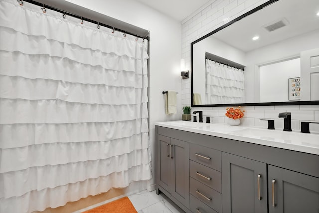 4396 Laurel Dr, Saint Joseph, MI 49085 - full bathroom with marble look tile flooring, double vanity, decorative backsplash, recessed lighting, and curtained shower