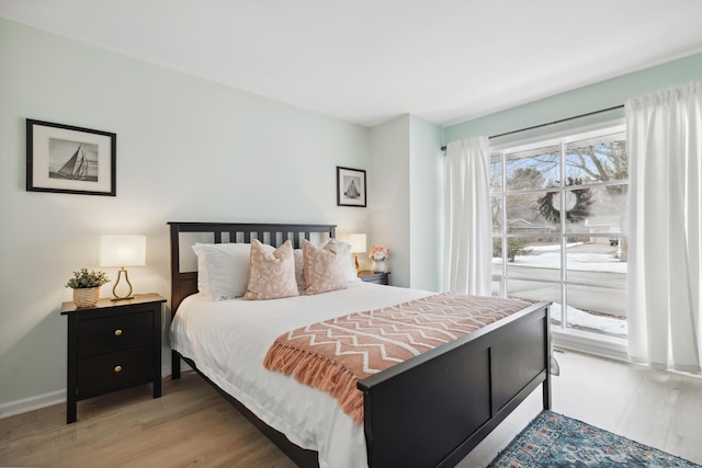 4396 Laurel Dr, Saint Joseph, MI 49085 - bedroom featuring access to exterior, light wood-type flooring, and baseboards