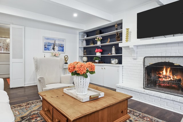 4396 Laurel Dr, Saint Joseph, MI 49085 - living room with beamed ceiling, dark wood-style flooring, and a brick fireplace