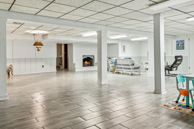 4396 Laurel Dr, Saint Joseph, MI 49085 - below grade area featuring wood finished floors, a fireplace, and a paneled ceiling