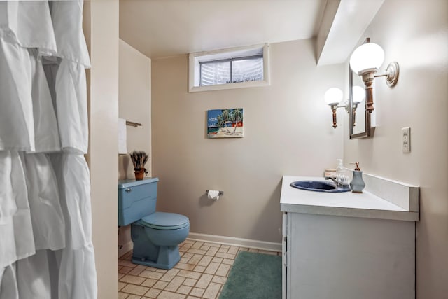 4396 Laurel Dr, Saint Joseph, MI 49085 - bathroom featuring vanity, toilet, baseboards, and brick patterned floors