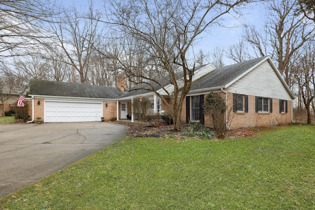 4396 Laurel Dr, Saint Joseph, MI 49085 - view of front of house with brick siding, driveway, a chimney, a front lawn, and an attached garage