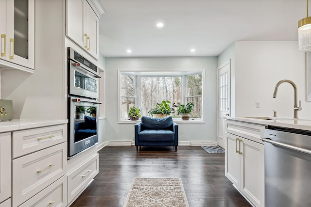 4396 Laurel Dr, Saint Joseph, MI 49085 - kitchen with stainless steel appliances, a sink, light countertops, white cabinetry, and dark wood-style floors