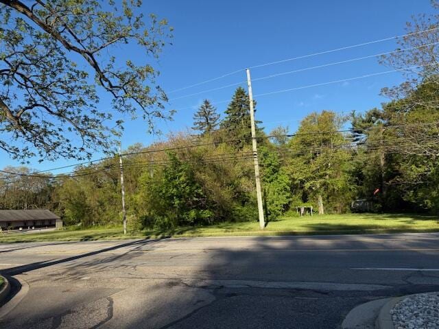 4401 Grand Haven Rd, Norton Shores, MI 49441 - view of asphalt road featuring curbs