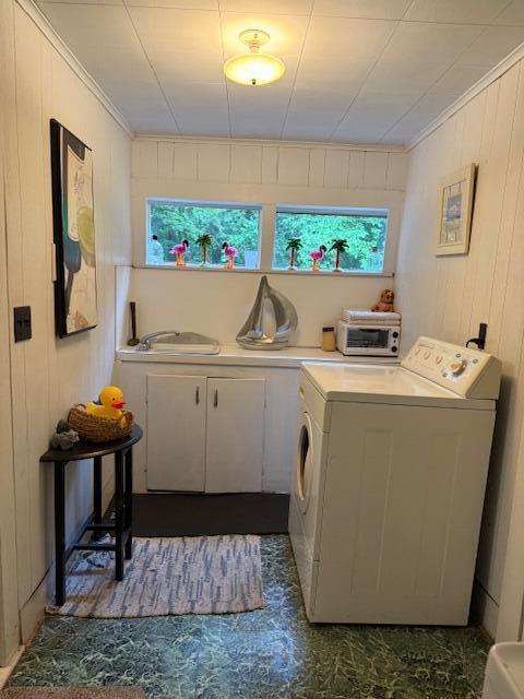4401 Grand Haven Rd, Norton Shores, MI 49441 - washroom featuring cabinet space, washing machine and clothes dryer, crown molding, and wooden walls