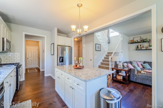 32879 Birchwood Dr, Chesterfield, MI 48047 - kitchen featuring stainless steel appliances, white cabinets, dark wood-type flooring, and a chandelier