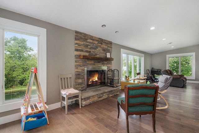 1710 Kreft St NE, Grand Rapids, MI 49525 - living room featuring a stone fireplace, wood finished floors, lofted ceiling, recessed lighting, and baseboards