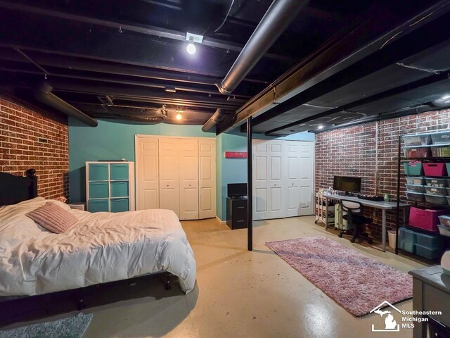 1997 Teton Ave, Monroe, MI 48162 - bedroom with brick wall, concrete flooring, and multiple closets