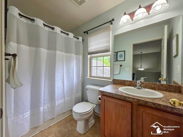 1997 Teton Ave, Monroe, MI 48162 - bathroom with vanity, toilet, tile patterned flooring, and shower / tub combo