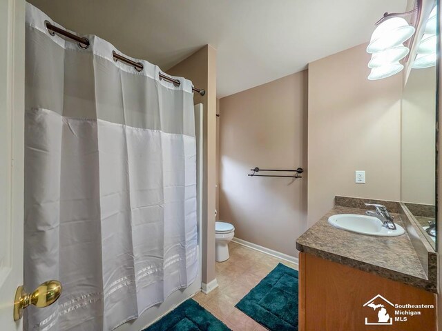 1997 Teton Ave, Monroe, MI 48162 - full bathroom featuring vanity, toilet, tile patterned floors, baseboards, and a shower with curtain