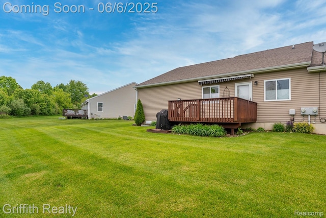2870 Grand Marais Dr, Howell, MI 48843 - rear view of property featuring a deck and a yard