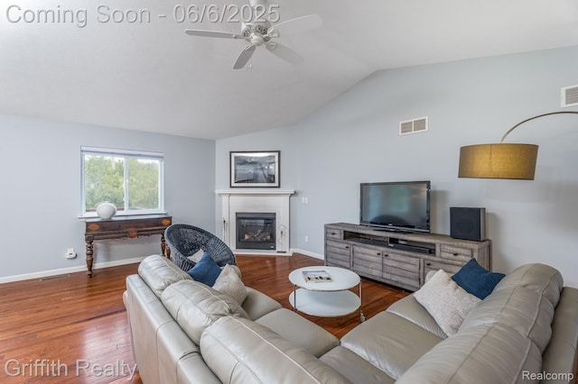 2870 Grand Marais Dr, Howell, MI 48843 - living room with ceiling fan, vaulted ceiling, wood finished floors, a glass covered fireplace, and baseboards