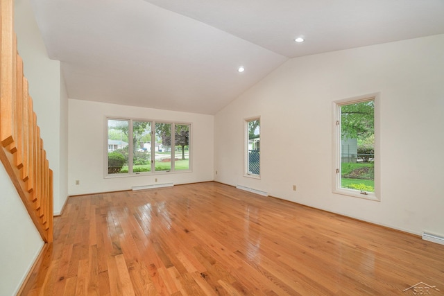 5211 S Gatesboro Dr, Saginaw, MI 48603 - empty room featuring a baseboard heating unit, light wood finished floors, plenty of natural light, vaulted ceiling, and recessed lighting