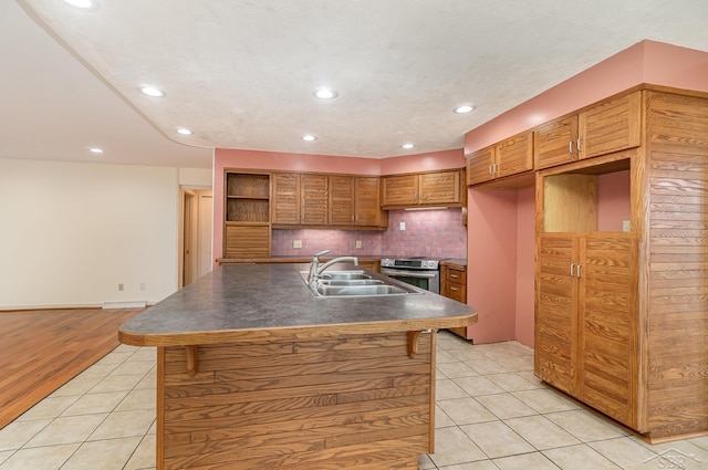 5211 S Gatesboro Dr, Saginaw, MI 48603 - kitchen with a sink, open shelves, light tile patterned flooring, stainless steel range with electric cooktop, and dark countertops