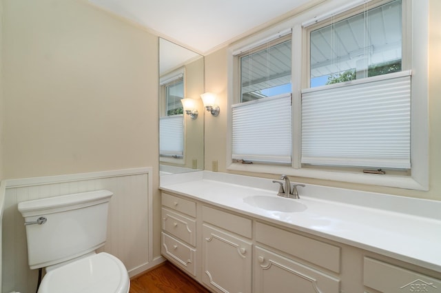 5211 S Gatesboro Dr, Saginaw, MI 48603 - bathroom featuring vanity, toilet, wood finished floors, and wainscoting