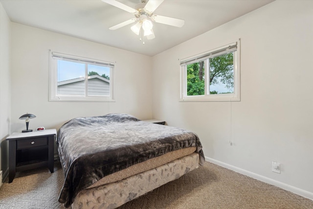 5371 Durwood Dr, Swartz Creek, MI 48473 - carpeted bedroom featuring multiple windows, baseboards, and a ceiling fan