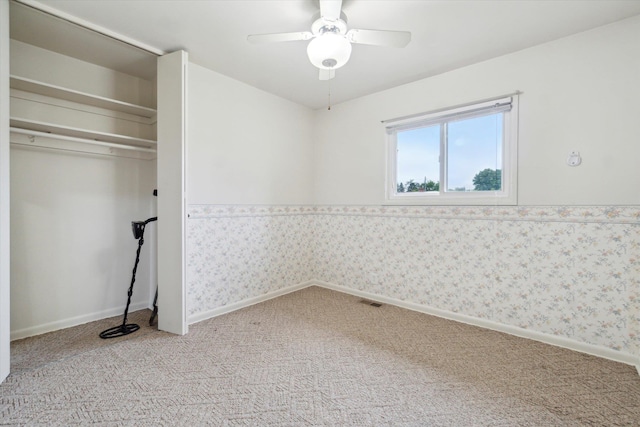 5371 Durwood Dr, Swartz Creek, MI 48473 - unfurnished bedroom with light carpet, ceiling fan, baseboards, a closet, and wallpapered walls