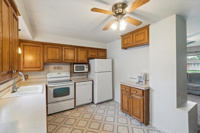 5371 Durwood Dr, Swartz Creek, MI 48473 - kitchen featuring white appliances, brown cabinets, a ceiling fan, and light countertops