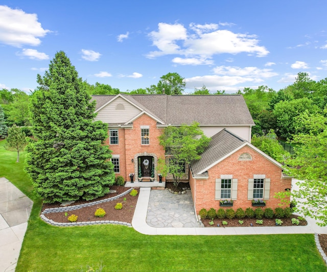 1150 Heatherlea Ct, Canton, MI 48188 - traditional-style house featuring roof with shingles, brick siding, and a front yard