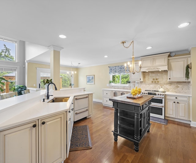 1150 Heatherlea Ct, Canton, MI 48188 - kitchen with range with two ovens, a sink, butcher block counters, cream cabinetry, and a chandelier