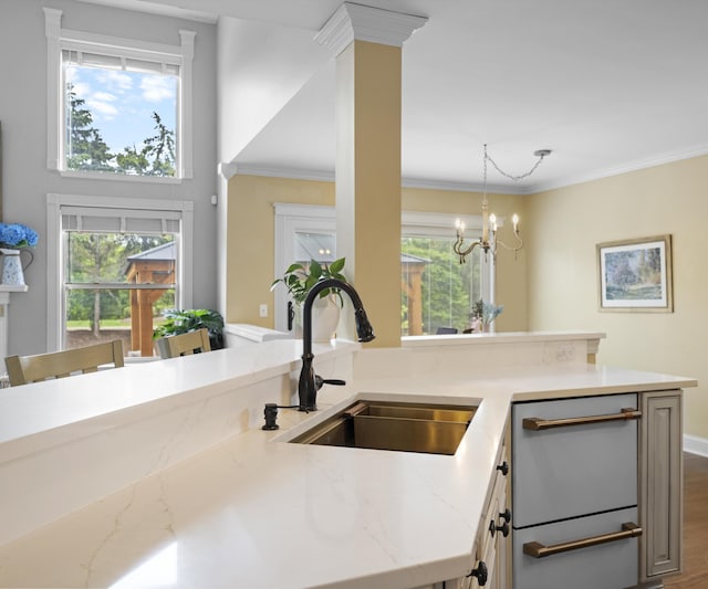 1150 Heatherlea Ct, Canton, MI 48188 - kitchen featuring a sink, light stone counters, plenty of natural light, a chandelier, and crown molding