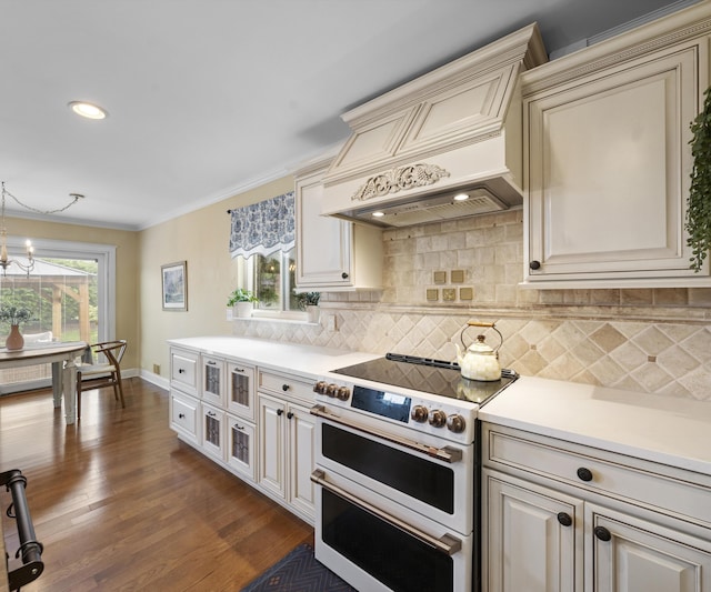 1150 Heatherlea Ct, Canton, MI 48188 - kitchen with double oven range, cream cabinetry, premium range hood, light countertops, and backsplash
