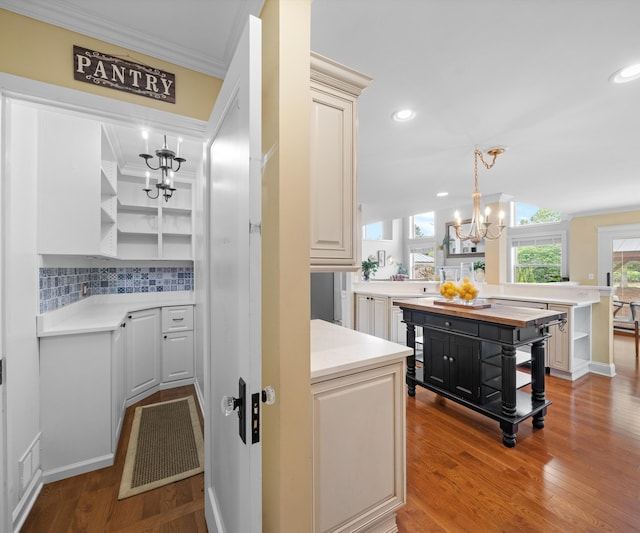 1150 Heatherlea Ct, Canton, MI 48188 - bar with a chandelier, backsplash, wood finished floors, ornamental molding, and recessed lighting