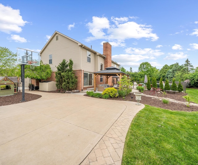 1150 Heatherlea Ct, Canton, MI 48188 - rear view of house with a gazebo, a chimney, curved driveway, brick siding, and a patio area