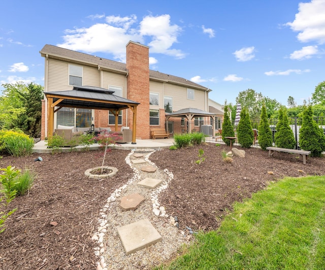 1150 Heatherlea Ct, Canton, MI 48188 - back of house with a gazebo, a chimney, a patio area, and brick siding
