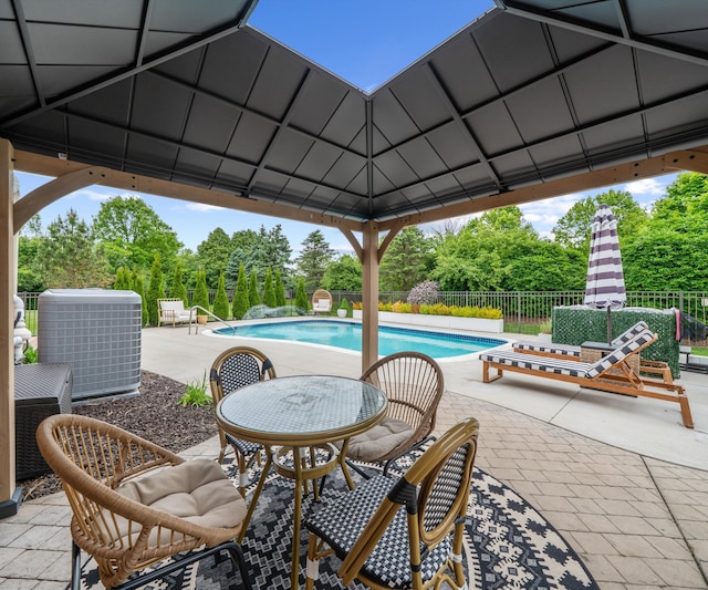 1150 Heatherlea Ct, Canton, MI 48188 - view of swimming pool featuring central AC, a gazebo, a patio, and view of wooded area