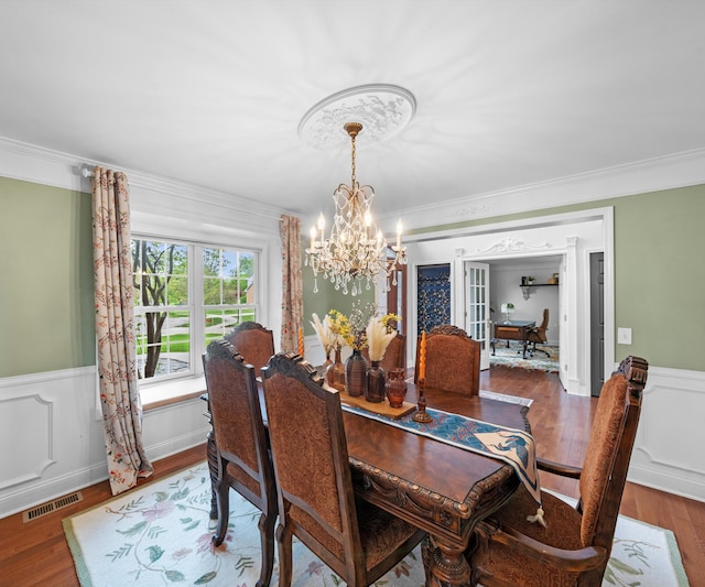 1150 Heatherlea Ct, Canton, MI 48188 - dining room with a chandelier, wood finished floors, crown molding, a wainscoted wall, and french doors