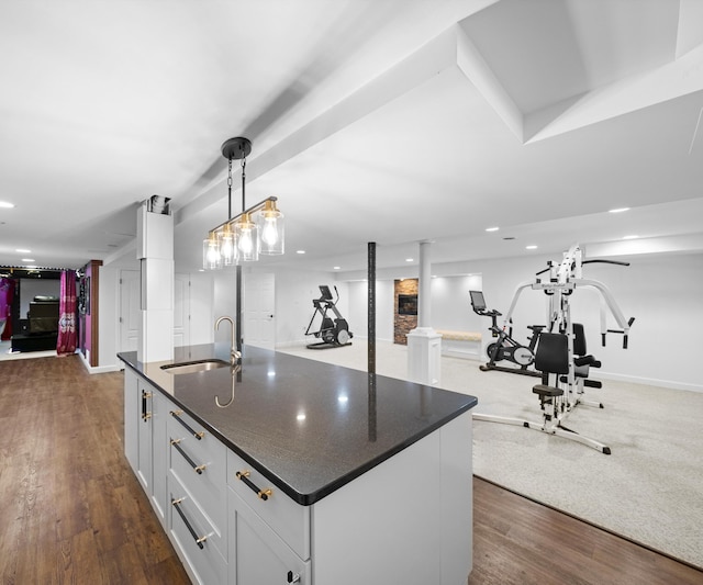 1150 Heatherlea Ct, Canton, MI 48188 - kitchen featuring a sink, open floor plan, white cabinetry, dark wood-style floors, and pendant lighting