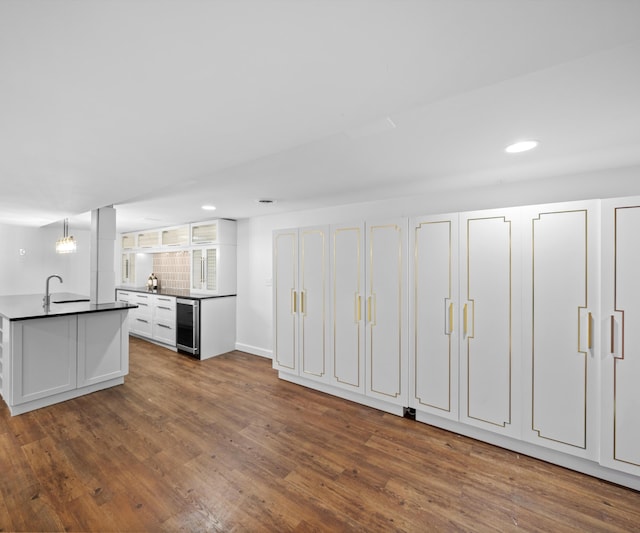 1150 Heatherlea Ct, Canton, MI 48188 - kitchen featuring wine cooler, recessed lighting, a sink, dark wood-type flooring, and white cabinetry