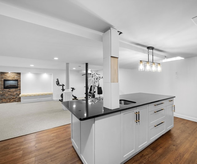 1150 Heatherlea Ct, Canton, MI 48188 - kitchen with dark countertops, open floor plan, dark wood finished floors, white cabinets, and recessed lighting