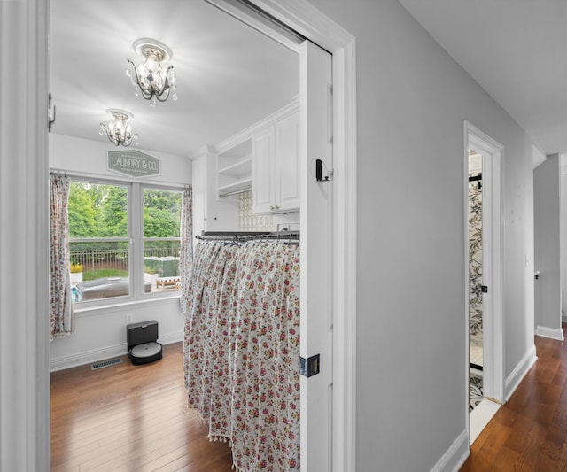 1150 Heatherlea Ct, Canton, MI 48188 - hallway featuring a chandelier, wood finished floors, and baseboards