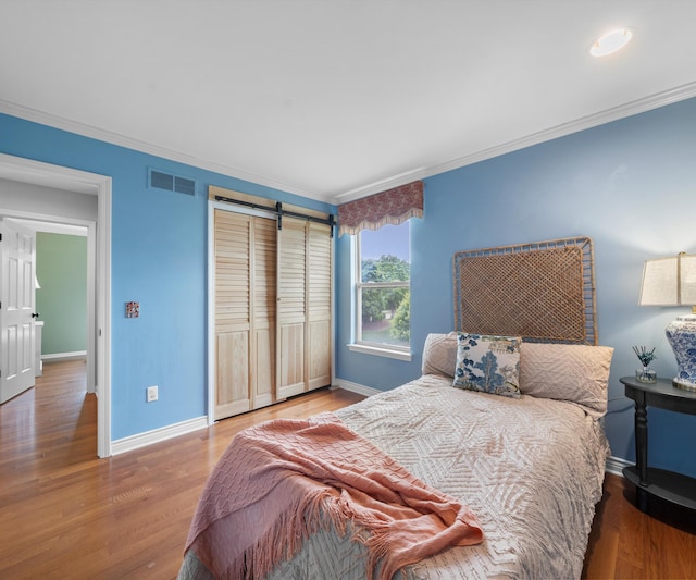 1150 Heatherlea Ct, Canton, MI 48188 - bedroom with crown molding, baseboards, wood finished floors, and a closet