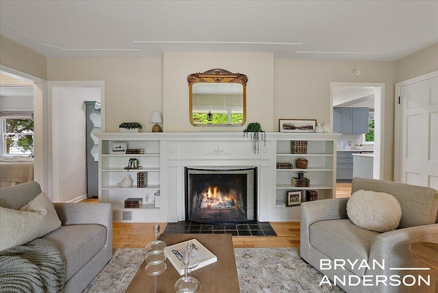 2120 Englewood Dr SE, East Grand Rapids, MI 49506 - living area featuring a fireplace with flush hearth and wood finished floors
