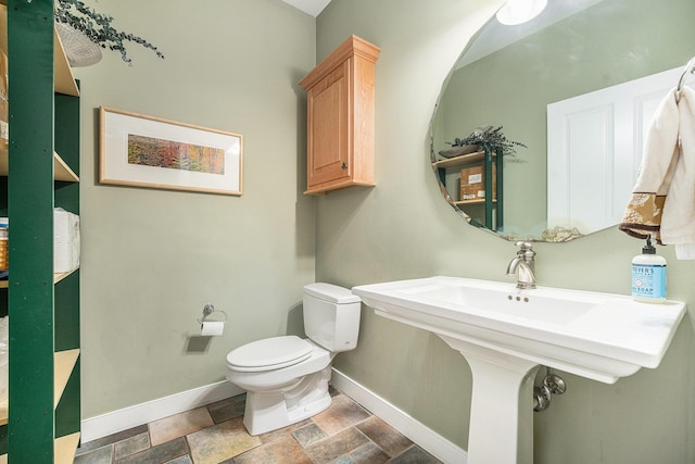 9266 Maricopa Trl, Kalamazoo, MI 49009 - half bath with toilet, baseboards, and stone finish floors