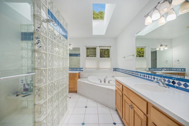 9266 Maricopa Trl, Kalamazoo, MI 49009 - full bathroom featuring a skylight, vanity, a shower stall, a garden tub, and tile patterned flooring