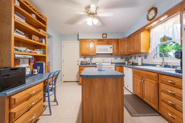 1605 Suffolk Ave, Portage, MI 49024 - kitchen featuring white appliances, a sink, dark countertops, a center island, and a ceiling fan
