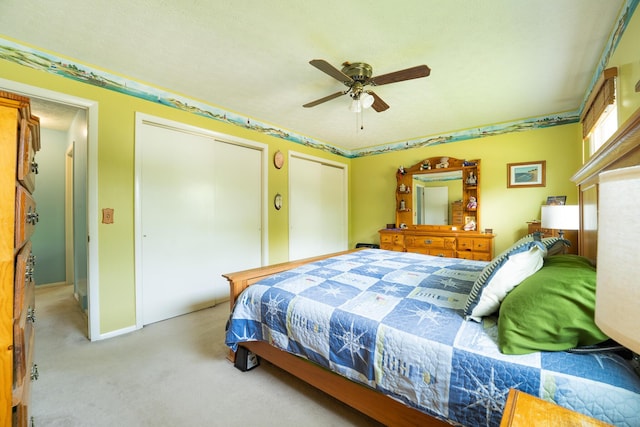 1605 Suffolk Ave, Portage, MI 49024 - bedroom with multiple closets, light carpet, a ceiling fan, and baseboards