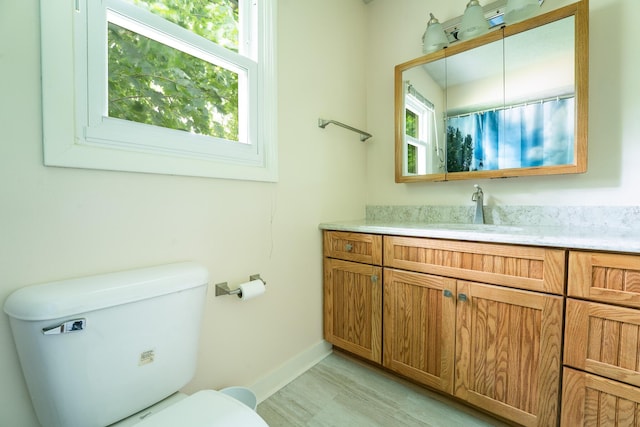 1605 Suffolk Ave, Portage, MI 49024 - full bathroom with toilet, plenty of natural light, vanity, and baseboards