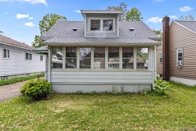 1141 E Madge Ave, Hazel Park, MI 48030 - back of property with a sunroom, roof with shingles, and a lawn