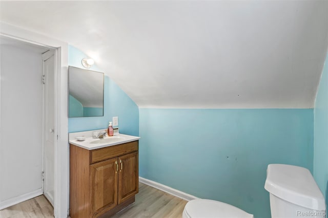 1141 E Madge Ave, Hazel Park, MI 48030 - half bathroom featuring toilet, wood finished floors, lofted ceiling, vanity, and baseboards
