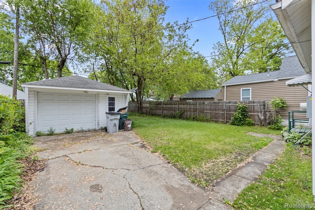 1141 E Madge Ave, Hazel Park, MI 48030 - view of yard with an outdoor structure, a detached garage, and driveway