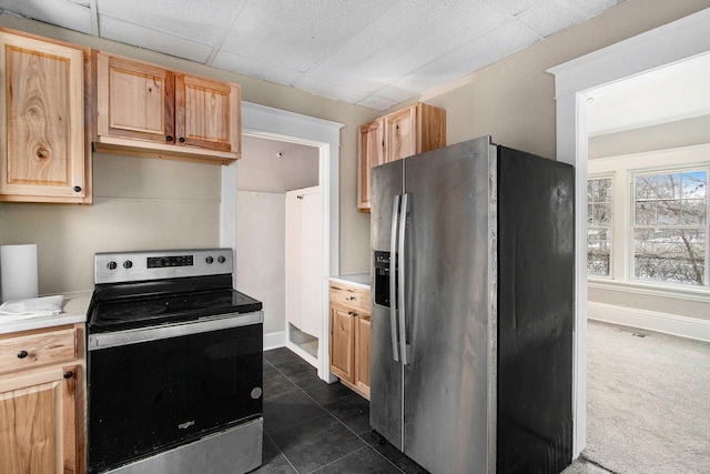 905 Lane Ave, Kalamazoo, MI 49001 - kitchen featuring stainless steel appliances, light countertops, light brown cabinetry, and dark tile patterned floors