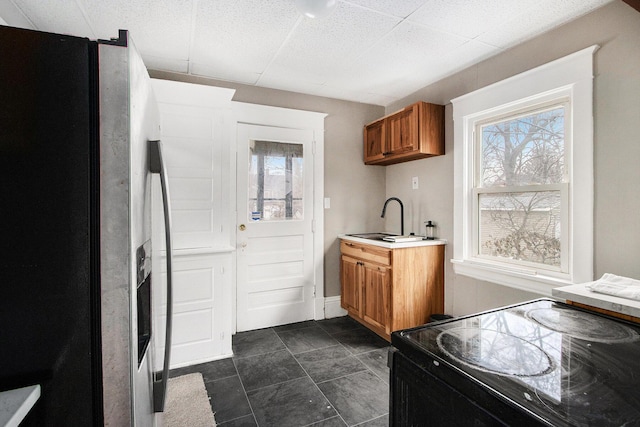 905 Lane Ave, Kalamazoo, MI 49001 - kitchen with stainless steel refrigerator with ice dispenser, electric range, a sink, brown cabinetry, and plenty of natural light
